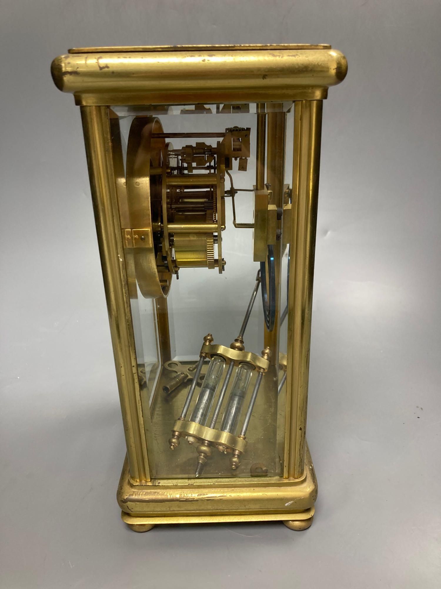 A four glass and brass mantel clock with mercury pendulum, 18cm high, 17cm wide,13cm deep